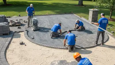 Professionals installing interlocking driveway pavers in Easton, PA with precise leveling and base prep